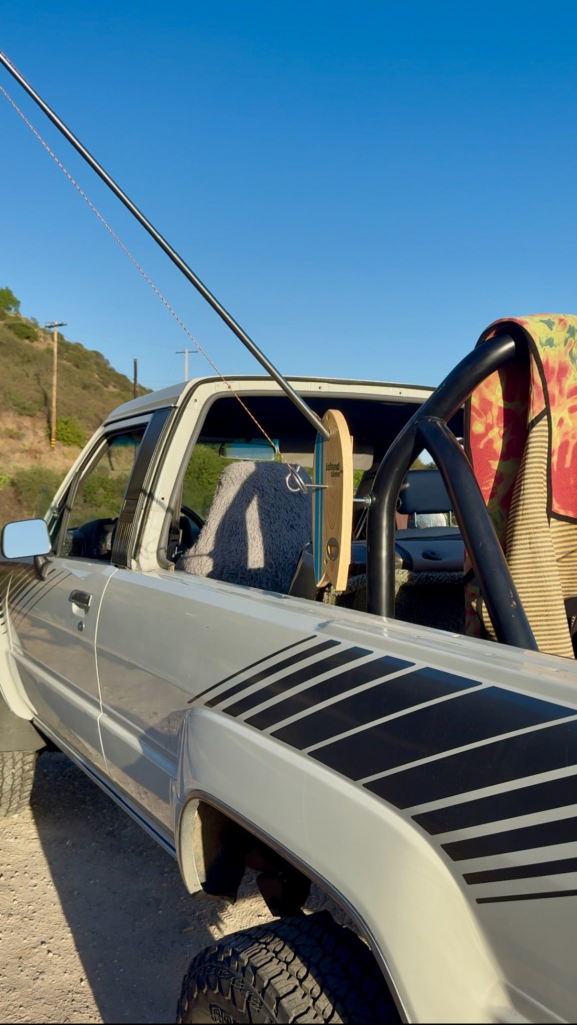 Island Time Bottle Opener Pro hook and ring game on an off-road truck with surfboards