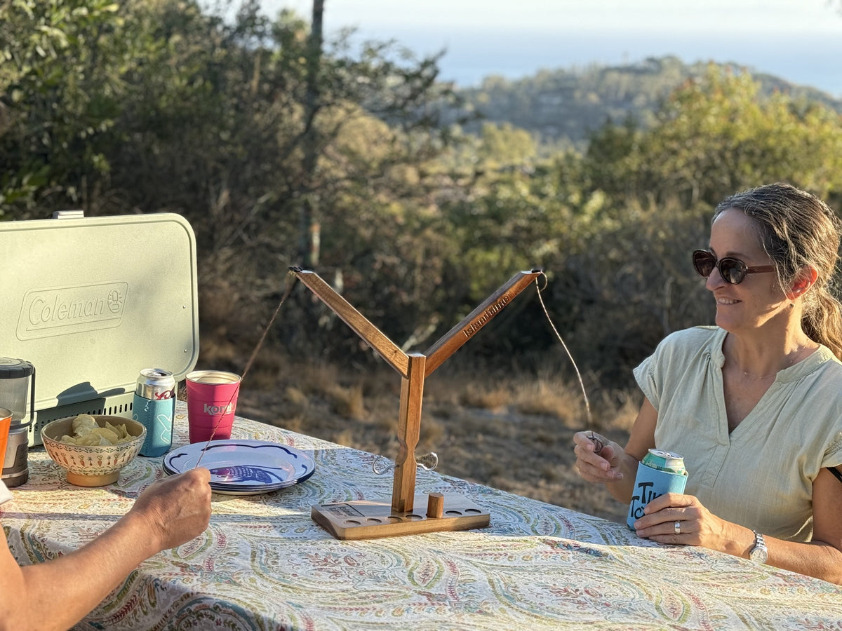 Island Time Head 2 Head game being played around a campsite table
