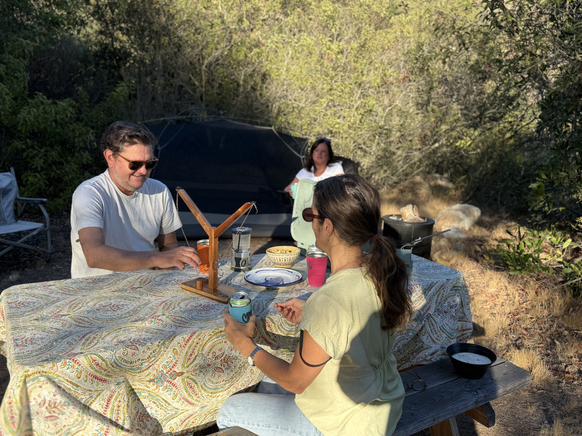 Friends playing an Island Time Head 2 Head game while camping